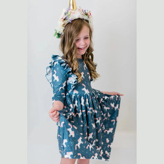 Side view of teal unicorn print kids dress showing full A-line skirt movement and ruffled sleeves