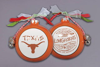 Two orange ceramic Texas Longhorns Christmas ornaments with jingle bells and ribbon bows