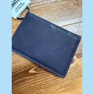 Flat lay of navy pebbled leather ID holder with Fanatic Group tag and precise edge stitching