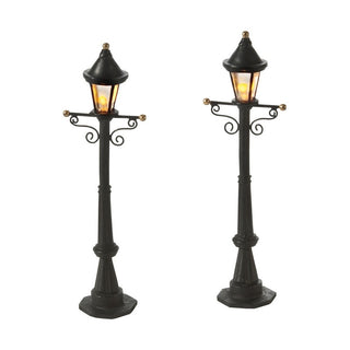 Two black decorative street lamp posts with warm LED lights and ornate scrollwork details