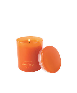 Aromatique Valencia Orange 10oz candle in orange glass jar with lid beside it