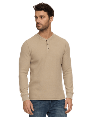 Man wearing a tan long-sleeve waffle-knit henley with two buttons and ribbed cuffs