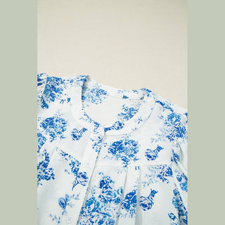 Detail of Viola blouse round neckline, white buttons, and chest pleated bust feature