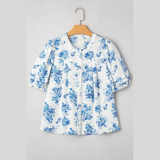 Front flat lay of Viola blue floral blouse with pleated bust and button placket