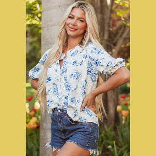 Relaxed fit Viola blue floral blouse with asymmetrical hem and ruffled cuff styling