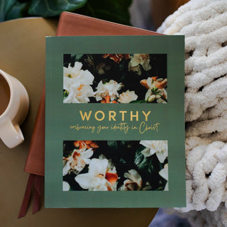 Worthy Bible Study book with green floral cover on a stack of journals