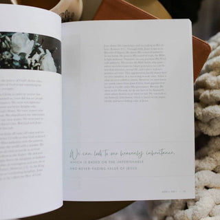 Worthy Bible Study book open to Week 2 Day 1 with floral imagery