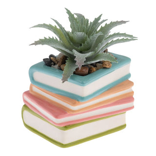 stack of books with a fake succulent