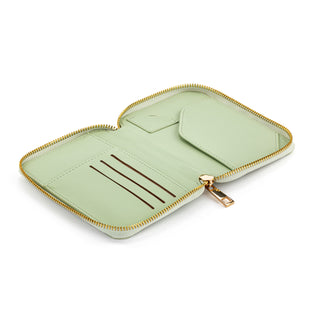 Open sage green zip-around passport wallet showing card slots and interior compartments with gold zipper