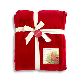 Demdaco red plush blanket folded with white ribbon bow and cardinal patch