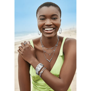 Model wearing Brighton Illumina Petite Collar layered silver necklace set at the beach.