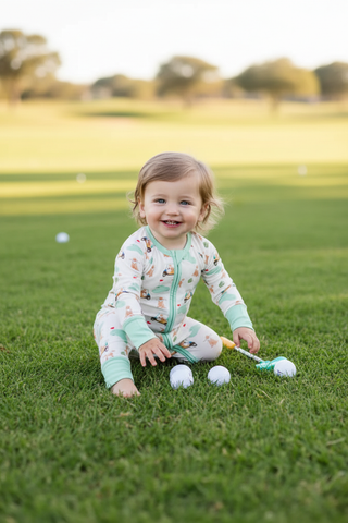 Barks & Birdies Zippie on grassy lawn with golf balls