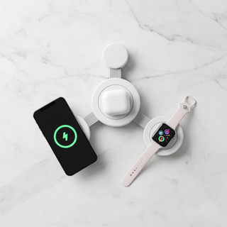 3-in-1 wireless charger flat lay on white marble with phone, smartwatch, and earbuds case
