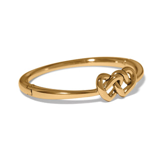 Brighton gold hinged bangle bracelet featuring interlocked linked hearts knot centerpiece design