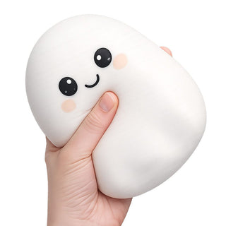 Hand squeezing a large white squishy ghost toy with cute kawaii face expression