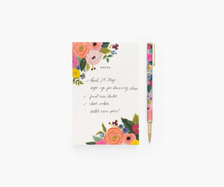 Rifle Paper Co. Garden Party floral pen beside matching floral notes notepad on white background