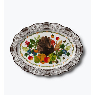 Oval white porcelain platter with turkey, harvest fruits, and dark floral scalloped border