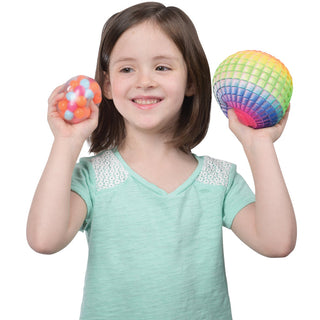 Young girl holding colorful bead-filled squeeze balls in both hands