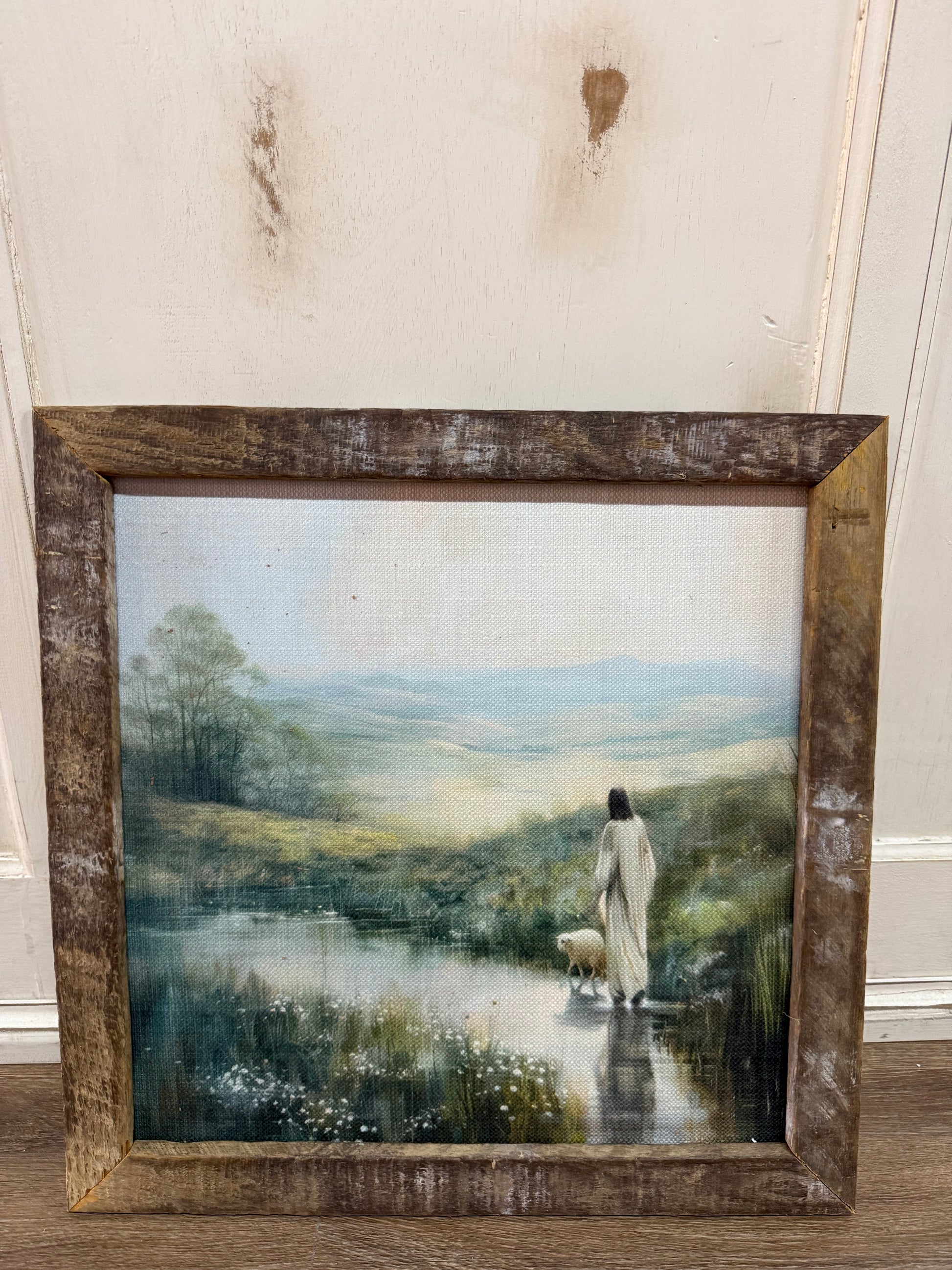 wooden frame with a painting of Jesus by the river