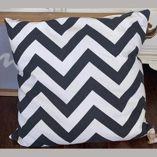 Grey 16 inch chevron pillow with bold black and white zigzag pattern on textured cotton fabric