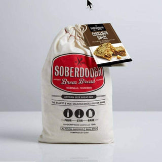 Cinnamon Swirl Soberdough beer bread mix in cream cotton drawstring bag with red logo and brown paper tag showing sliced bread texture
