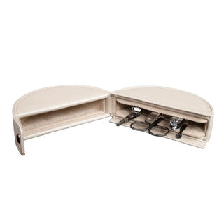 Open cream leather manicure case with stainless steel grooming tools and beige lining