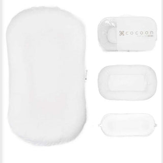 Solid white Cocoon Papillon baby lounger, plush organic cotton texture with mesh cover and padded base