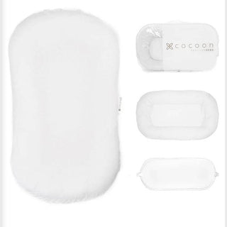 Cocoon Papillon Bebe white baby lounger with textured fabric, stitched trim, and removable thin pad for supervised rest