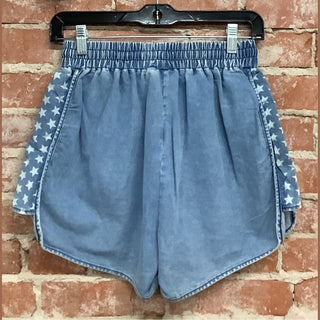 Light blue denim shorts with white star print side panels and gathered elastic waistband back view