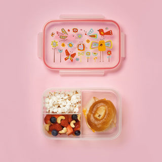 Open lunch bento box with birds pattern holding bagel sandwich and berries
