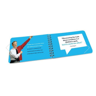 Angled view of Mister Rogers book page with self-discovery quote and partial photo of host in red cardigan