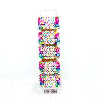 Assorted colorful vinyl heishi word bracelets for kids with stretch cord featuring PEACE SHINE SMILE HAPPY LOVE charms
