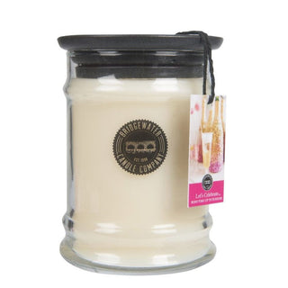 Bridgewater Let's Celebrate 8oz candle in textured glass jar with black ceramic lid and charitable hangtag