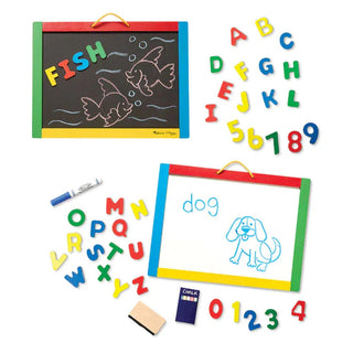 Melissa & Doug portable art board showing black chalkboard side with fish drawing and white dry-erase side with dog illustration and accessories
