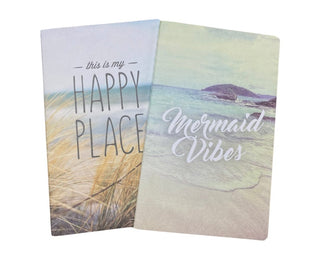 Two notebooks with beach-themed designs and text 