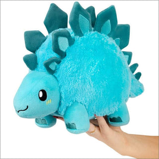 Small light turquoise Stegosaurus stuffed animal held in hand for size scale