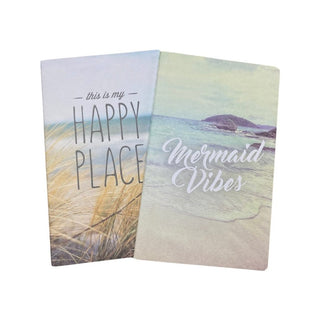Two notebooks with beach-themed designs and text 