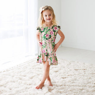 Toddler girl wearing pink bamboo viscose floral hi-low dress with ruffle hem