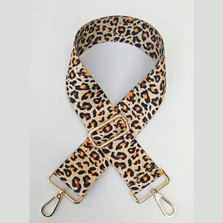 Beige base leopard print crossbody bag strap with orange-brown spots and X-shape layout