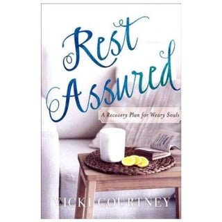 Book cover of 'Rest Assured' with a candle and book on a table 