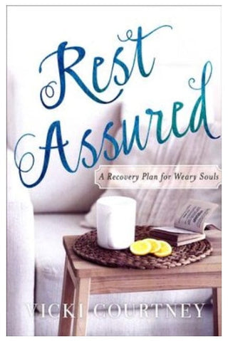 Book cover of 'Rest Assured' with a candle and book on a table 