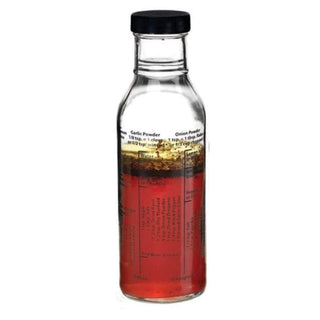 HIC glass salad dressing maker bottle with black cap, layered red vinaigrette and printed recipe measurements