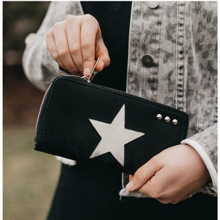 Black faux leather wallet with large white star patch worn with denim-style jacket