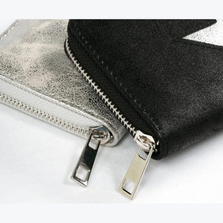 Close-up of silver crackled and black matte star wallets highlighting zipper teeth detail