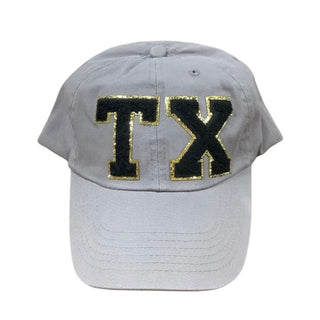 Light gray six-panel cap featuring black fuzzy TX varsity patch with gold trim