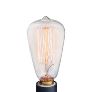 Warm amber glowing Edison filament bulb mounted on black candle warmer with brass ring